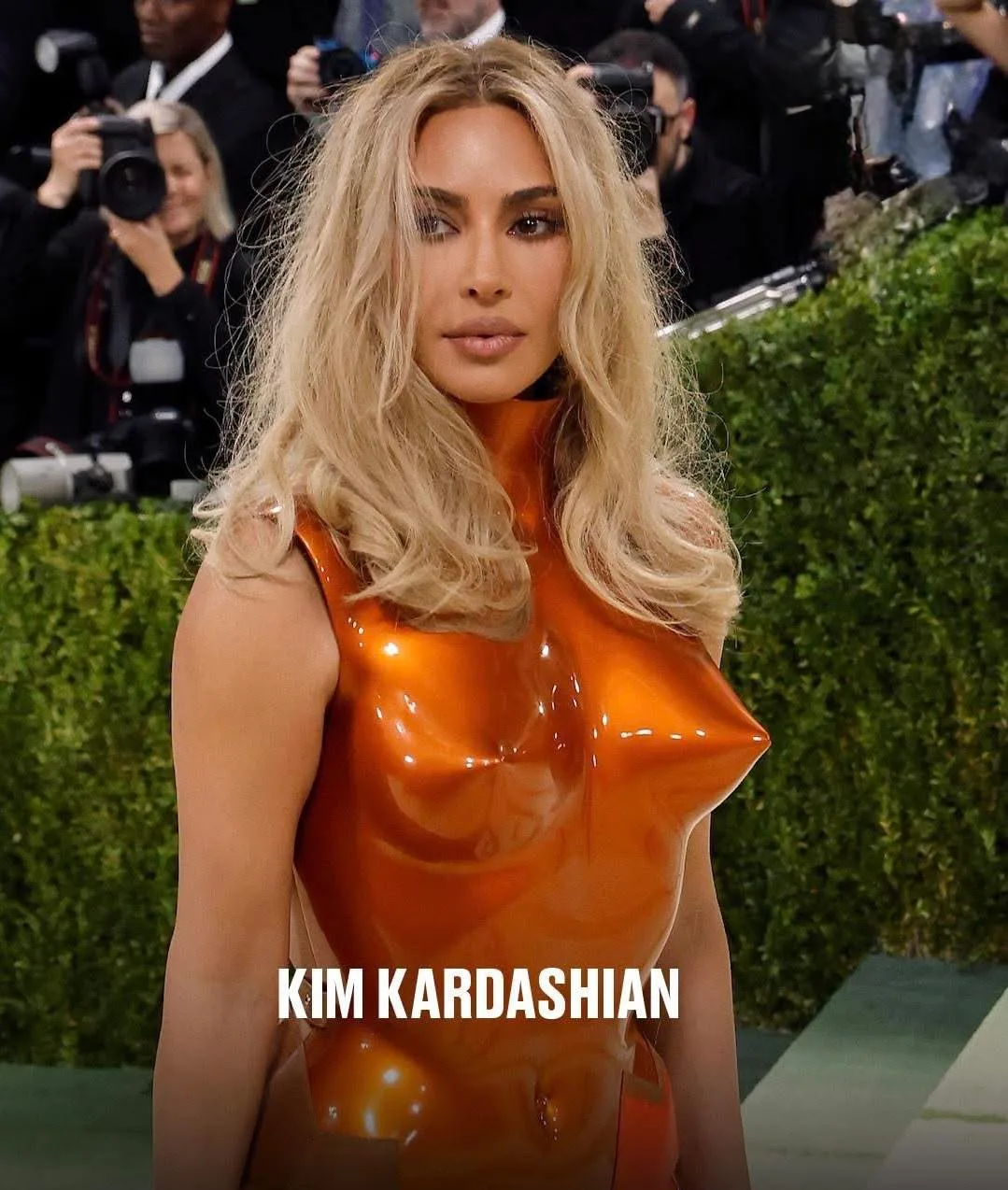 Kim Kardashian in a sculpted orange latex bodice on the Met Gala carpet.
