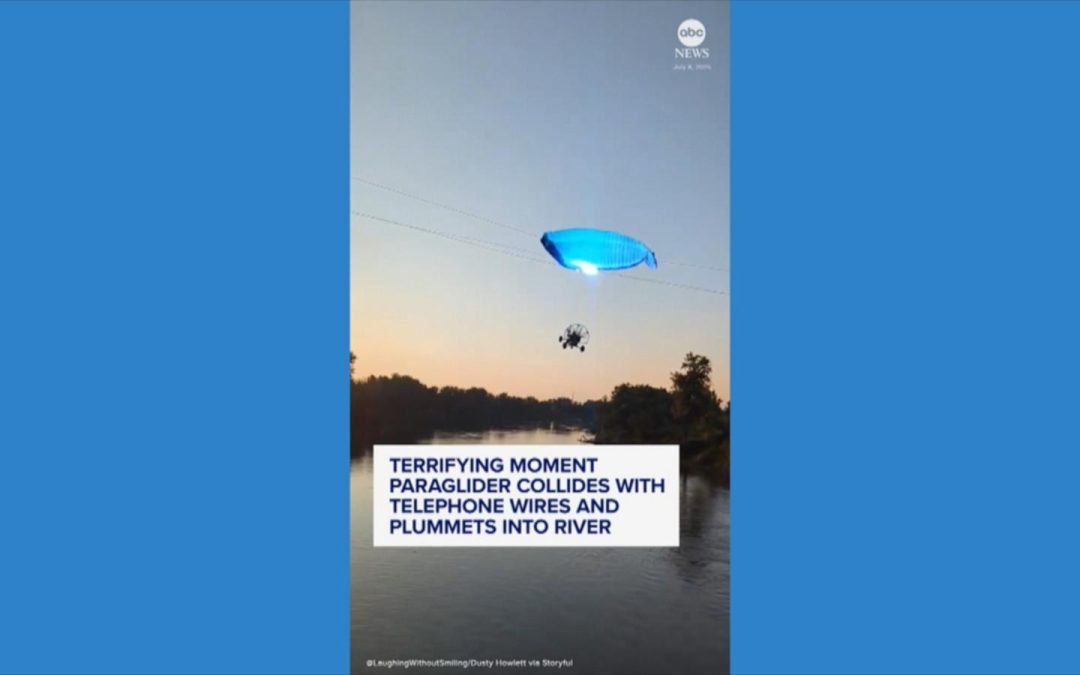 WATCH: Paraglider hits phone lines and plunges into river