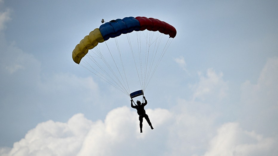Skydiver survives after reserve parachute accidentally deploys, leaving him dangling from flying airplane